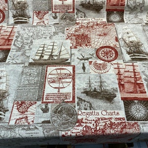 May include: A fabric with a nautical theme featuring a repeating pattern of maps, ships, compasses, and the text "Regatta Charts". The fabric is a light beige with brown and red accents.