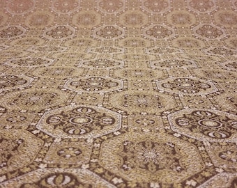 May include: A close-up of a patterned fabric with a repeating hexagonal design. The fabric is a mix of brown, gold, and white colours.