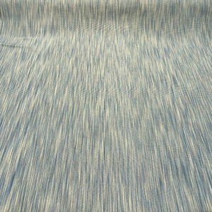 May include: A close-up of a blue and white striped fabric. The fabric has a subtle sheen and a slightly textured surface.