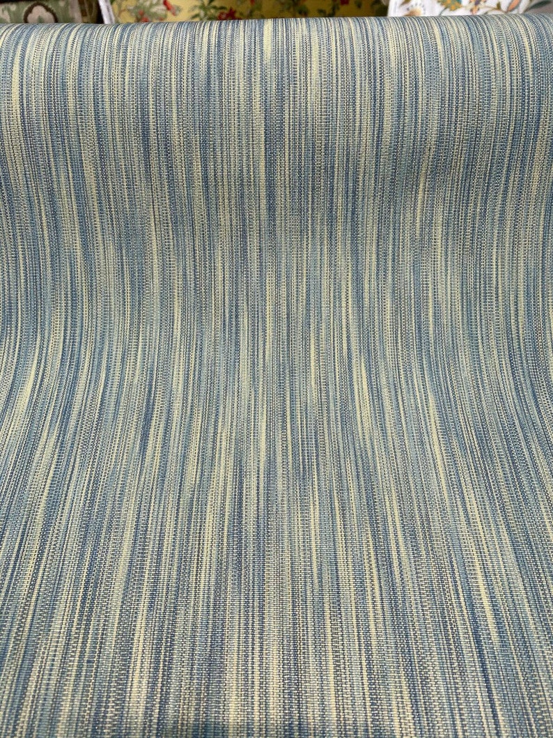 May include: A close-up of a blue and cream striped fabric with a subtle woven texture.