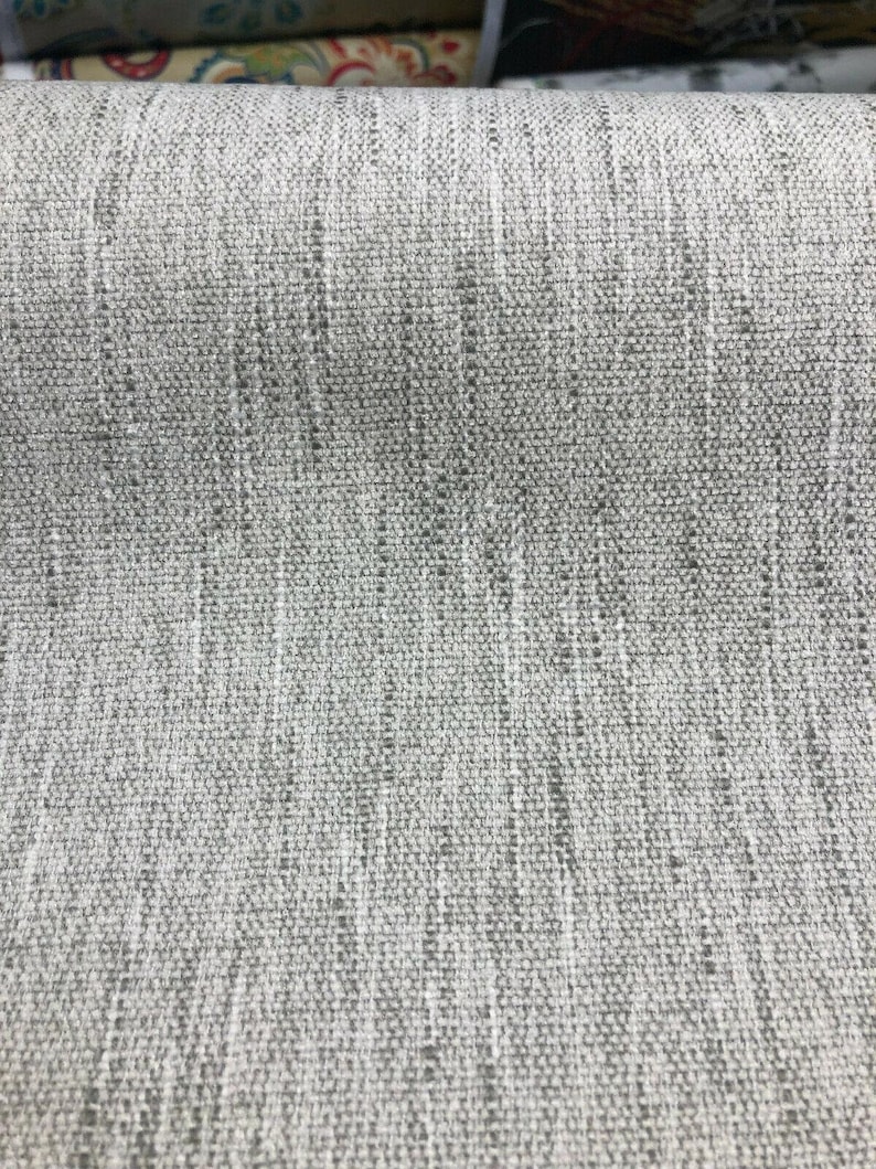 May include: Close-up of a gray textured fabric with a subtle woven pattern.