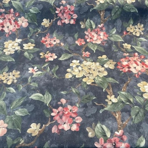 May include: A dark blue fabric with a floral pattern featuring pink and yellow flowers with green leaves.