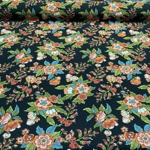 May include: Black fabric with a floral pattern featuring orange, pink, and blue flowers on a dark background.