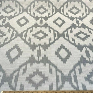 May include: White fabric with a gray geometric pattern. The pattern is a repeating design of diamonds and squares.