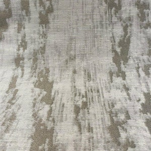 May include: A close-up of a white fabric with a subtle, textured, gray pattern. The fabric has a slightly shimmery appearance.