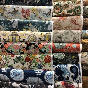 May include: A collection of fabric swatches featuring various floral and geometric patterns. The swatches are arranged in rows, with each row showcasing a different design. The fabrics are in a variety of colours, including blue, green, red, and yellow.
