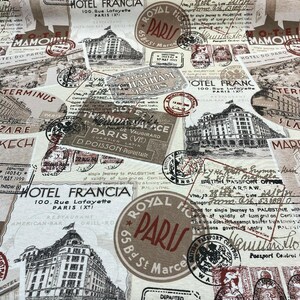May include: A beige fabric with a vintage travel theme. The fabric features a repeating pattern of stamps, hotel logos, and travel-related text. The text includes "Hotel Francia", "Royal Hotel Paris", and "British Passport Office".