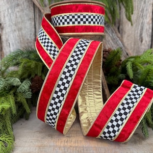 May include: A roll of decorative ribbon featuring a vibrant red velvet texture with a central black and white checkered pattern. The edges of the ribbon are trimmed with thin gold metallic piping, and the reverse side displays a solid gold finish.
