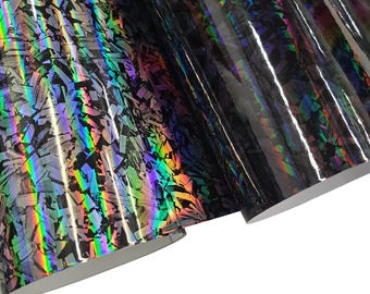 May include: Black iridescent vinyl with a shattered glass pattern. The vinyl has a holographic finish that shimmers with rainbow colors.