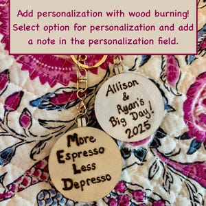May include: Two wooden keychains with gold-colored hardware. One keychain says "More Espresso Less Depresso" in a burnt wood style. The other keychain says "Allison & Ryan's Big Day! 2025".