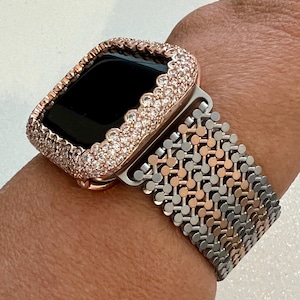 May include: A rose gold Apple Watch with a diamond-encrusted bezel and a silver and rose gold Milanese loop band.