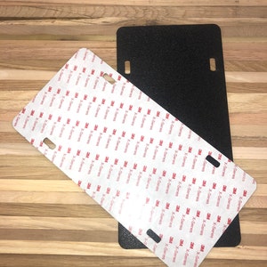 May include: Two black license plate blanks with adhesive backing. The adhesive backing is covered with 3M X-Series adhesive.