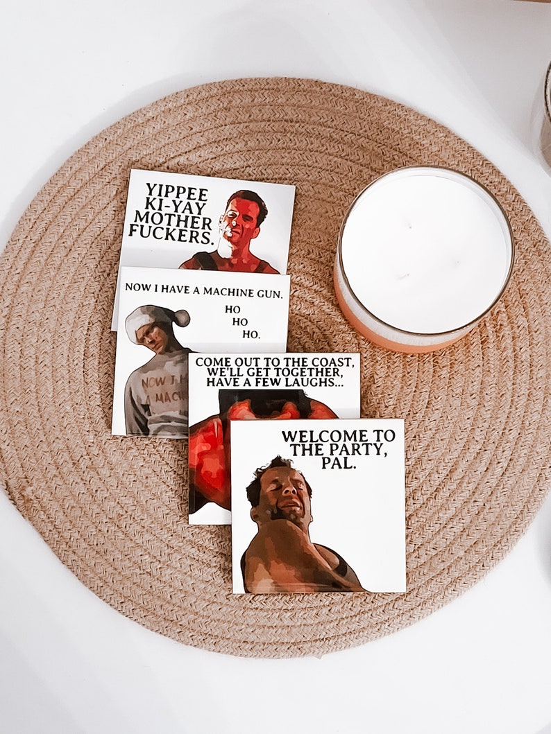 May include: Three stickers featuring characters from the film 'Die Hard'. The first sticker features the character John McClane with the text 'Yippee Ki-Yay Mother Fuckers'. The second sticker features the character John McClane with the text 'Now I have a machine gun. Ho Ho Ho'. The third sticker features the character John McClane with the text 'Come out to the coast, we'll get together, have a few laughs... Welcome to the party, pal.'