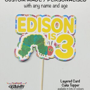 May include: A layered card cake topper featuring a colorful caterpillar and the text "EDISON IS 3". The topper is made of cardstock and is available in a variety of colors.