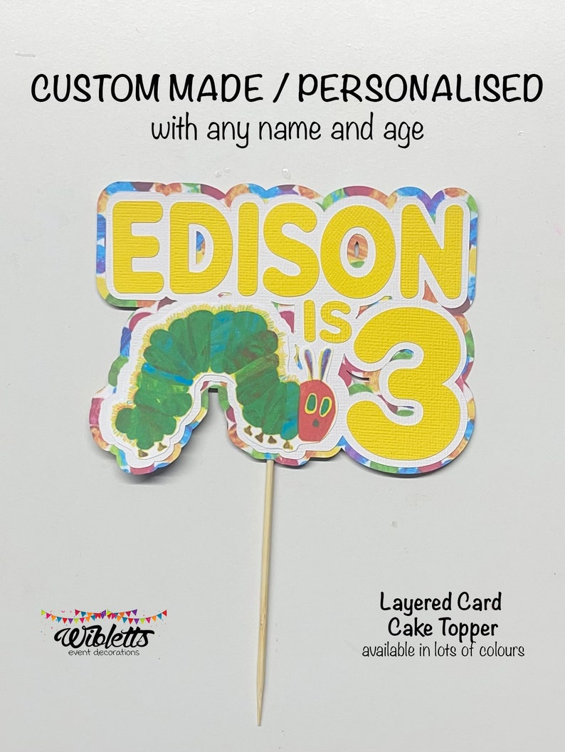 May include: A layered card cake topper featuring a colorful caterpillar and the text "EDISON IS 3". The topper is made of cardstock and is available in a variety of colors.