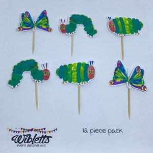 May include: A set of 6 The Very Hungry Caterpillar themed cupcake toppers. The set includes 2 green caterpillars with red faces, 2 green caterpillars with red faces and purple antennas, and 2 colorful butterflies.