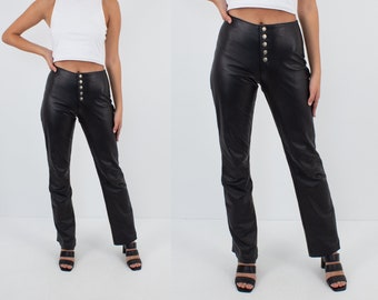 May include: Black leather pants with a button fly and a straight leg silhouette.