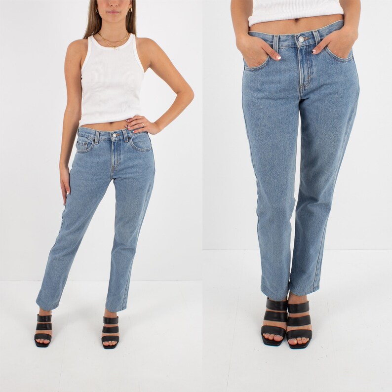 May include: A pair of light blue denim jeans with a straight leg fit. The jeans have a classic five-pocket style and a button fly.