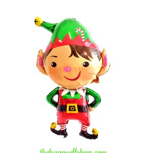 May include: A green and red Christmas elf balloon with a green hat, a red and white candy cane, and a gold belt buckle. The elf is smiling and has a brown hair.