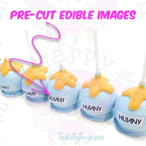 May include: Pre-cut edible images of blue candy apples with yellow caramel topping. Each apple has a white label with the word "HUUNY" in black. The image also includes the text "PRE-CUT EDIBLE IMAGES" in pink.