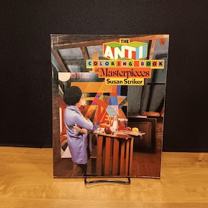 May include: The Anti-Coloring Book of Masterpieces by Susan Striker. The book cover features a colorful abstract painting and a person in a blue coat. The title is in a bold, colorful font.