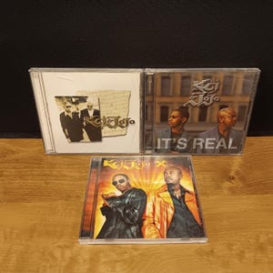 May include: Three CD cases featuring the music group K-Ci & JoJo. The top two cases have images of the duo in suits and sunglasses. The bottom case has a photo of the duo in leather and an orange jacket. The text "It's Real" is visible on one case.