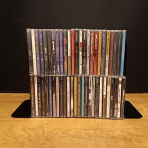 May include: A rustic wooden sign with the text "Welcome to our home" in a handwritten style. The sign features a distressed finish and a simple, inviting design, perfect for a front porch or entryway.