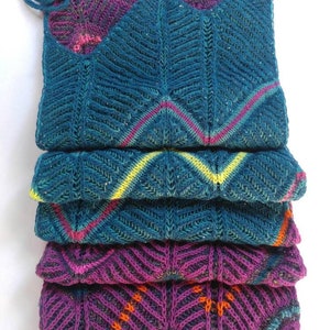 May include: A stack of five knitted scarves in teal, purple, and orange with a chevron pattern.