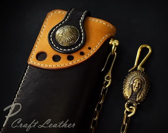 May include: A black and brown leather wallet with a chain and a brass Indian head pendant. The wallet has a flap with a brass button and a stitched design. The text "P Craft Leather" is visible in the bottom left corner.