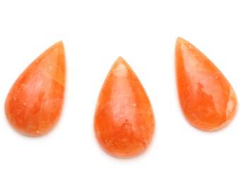 May include: Three teardrop-shaped orange gemstone cabochons, each with a slightly different shade of orange.