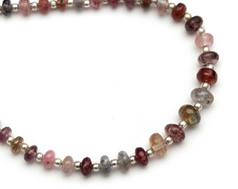 May include: A strand of multi-colored gemstone beads with silver spacer beads. The beads are a mix of pink, red, brown, and gray.