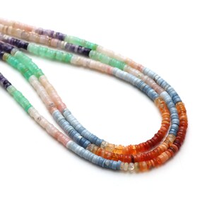 May include: A multi-strand necklace made of small, round beads in various colors, including purple, green, pink, blue, orange, and red. The beads are arranged in a gradient pattern, starting with purple and ending with red.
