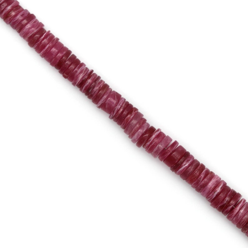 May include: A strand of pink and white gemstone beads. The beads are round and flat, and they are strung on a clear thread.