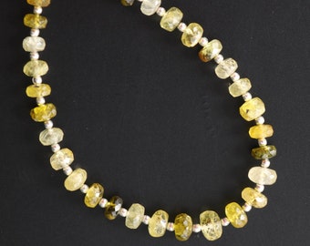 May include: A necklace made of faceted yellow and green gemstone beads separated by silver beads.