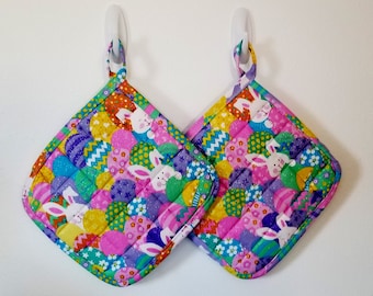 Set of two 9 inch Easter and spring handmade, quilted pot holders, hot pads with bunnies, with multiple colored glittery Easter eggs