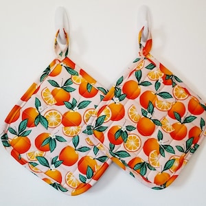 Set of 2 large handmade, quilted bright oranges pot holders, hot pads with a light orange background, great house warming gift