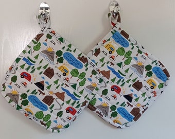 Set of 2 large quilted handmade colorful and fun camping themed potholders, with a white background. Great gift for anyone who camps.