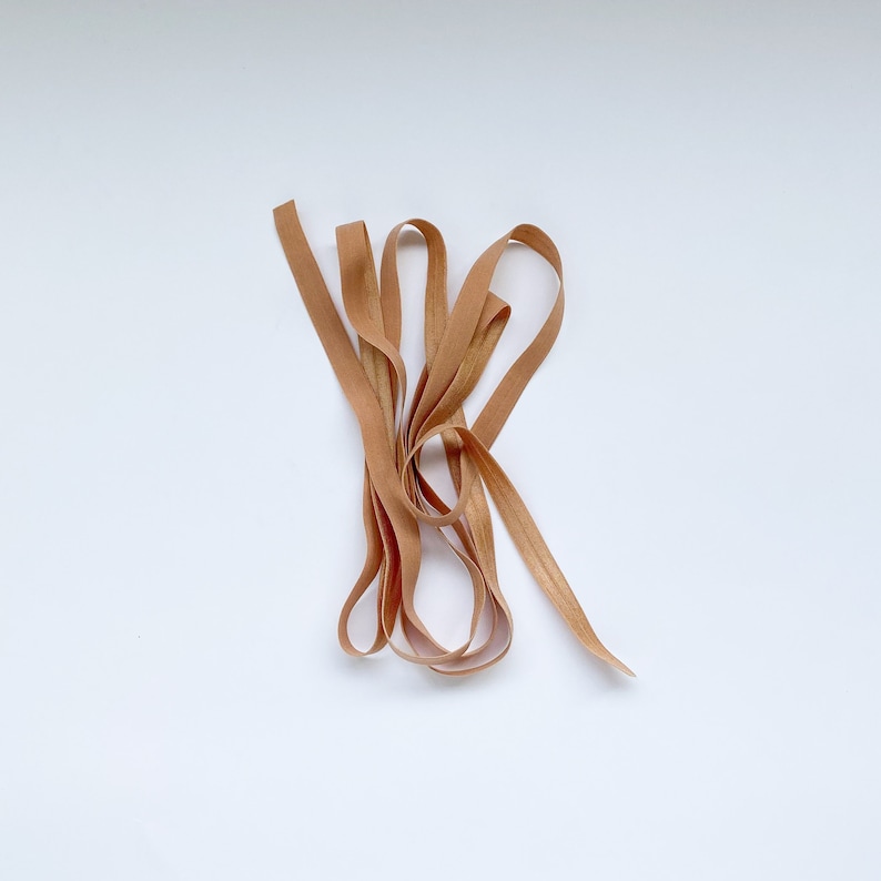 May include: A bundle of brown elastic ribbon, perfect for crafting or adding a touch of rustic charm to your projects.