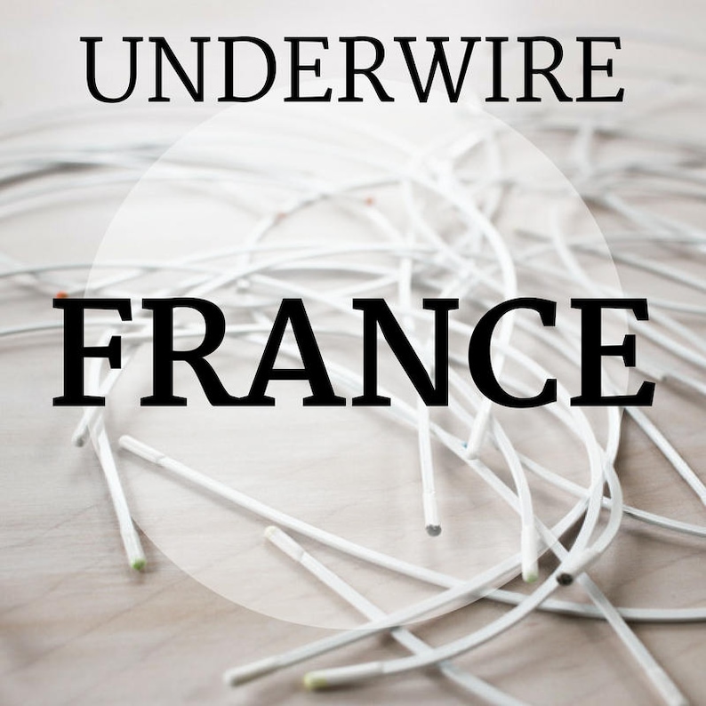 May include: A close-up of a pile of white underwire, with the word "UNDERWIRE" in black text at the top of the image and the word "FRANCE" in black text at the bottom of the image.