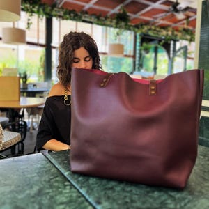 Handmade tote bag in full grain bordo Italian leather, Large size shown with exterior pocket and natural suede interior — stylish work or travel purse for her.