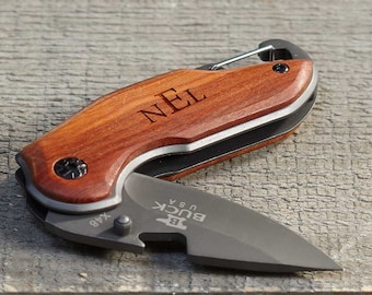 May include: Two personalized pocket knives with wooden handles. The knives are closed and have the initials "MJB" and "NEL" engraved on the handles.