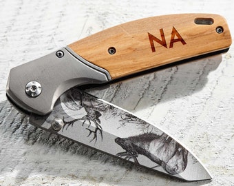 May include: A pocket knife with a wooden handle engraved with the initials "NA". The blade is stainless steel and features a deer design.