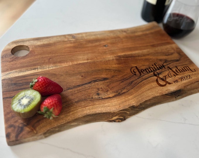 Add a personal touch to your kitchen with our laser-engraved live edge Mango wood cutting board - personalized