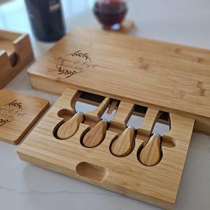 Image featuring a personalized bamboo cheese board paired with matching engraved coasters, styled together on an elegant serving table.