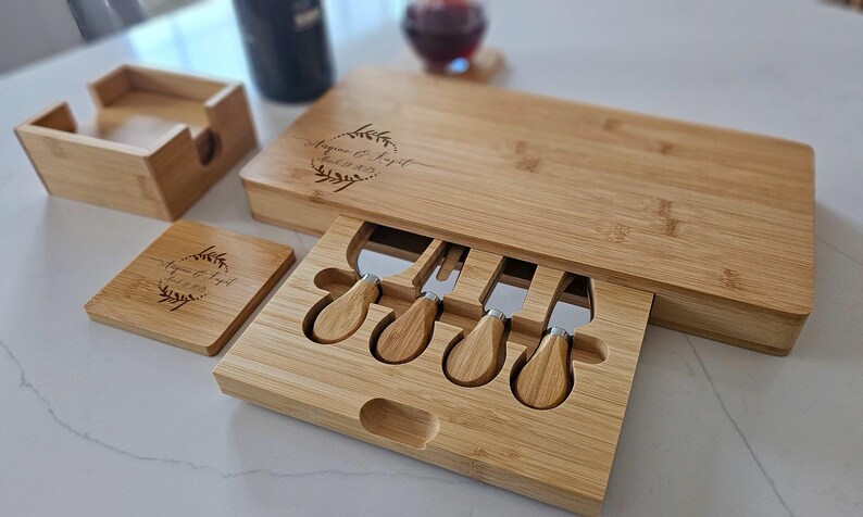 Image featuring a personalized bamboo cheese board paired with matching engraved coasters, styled together on an elegant serving table.