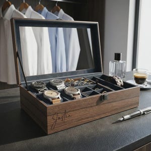 May include: A wooden watch and jewelry box with a mirrored lid, open to display watches, rings, and bracelets. The box is brown with a dark blue interior. The name "Justin" is written on the front in cursive.