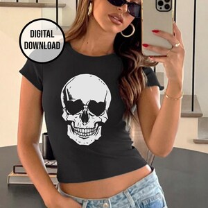 May include: A black cropped t-shirt with a white skull graphic wearing sunglasses. The skull has a toothy grin.