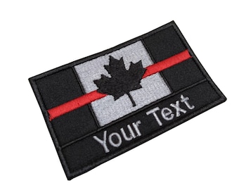 May include: Black and grey embroidered patch with a red stripe and a black maple leaf. The text "Your Text" is embroidered in grey below the maple leaf.