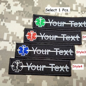 May include: Four black embroidered patches with a medical symbol and the text "Your Text" in white. The medical symbol is in different colours: green, red, blue, and black. The text "Style 1", "Style 2", "Style 3", and "Style 4" is next to each patch.