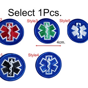 May include: Five different styles of embroidered medical patches, each with a blue background and a white star of life symbol. The star of life symbol is surrounded by a snake wrapped around a rod. The patches are 4 cm in diameter. Select 1Pcs.